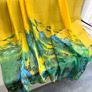 Detail of thin chiffon scarf with yellow landscape painting and soft texture drape