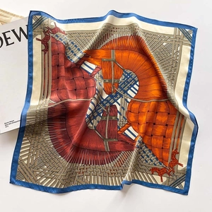 Detail of silk square scarf featuring equestrian patterns with horse head and leather weave