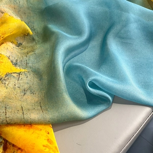 Detailed view of lightweight artistic oil painting silk scarf with blue and yellow gradient