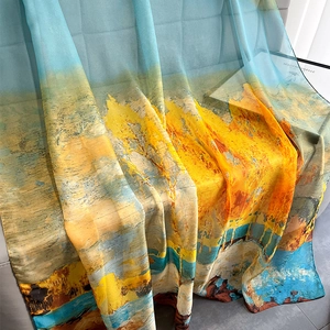 Detail of oil painting style silk scarf showing sheer fabric and vivid blue landscape