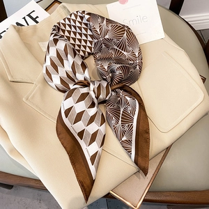Elegant checkered satin square scarf in coffee and beige knotted on a stylish blazer