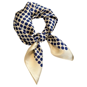 Champagne silk square scarf with navy polka dots and a smooth satin finish texture