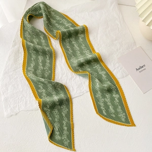 Detail of green pleated twilly scarf with white floral print and yellow borders