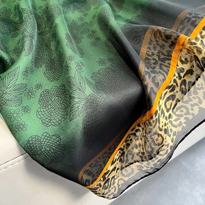 Emerald floral beach shawl with leopard print trim and lightweight silk texture