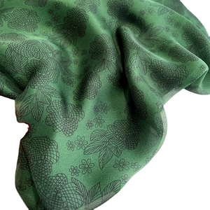Emerald green emerald beach scarf with black floral print and silky texture fabric