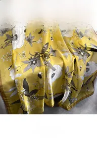 Detail of floral printed yellow silk scarf with honeybee and botanical patterns