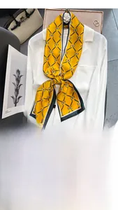 Macro detail of silk scarf tied as a tie on shirt with vintage horse print design