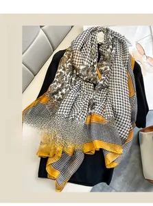 Detail of houndstooth paisley print shawl used as a versatile sunscreen beach towel