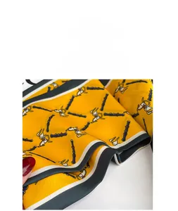 Detail of premium imitation silk scarf with classic horse harness pattern and contrast edges