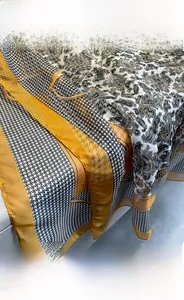 Detail of yellow and black houndstooth scarf with paisley pattern in plant dye silk