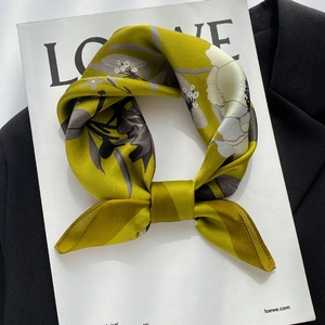 Vintage mustard yellow silk scarf with floral print on a white magazine background