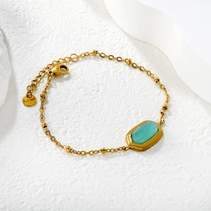 18k gold plated stainless steel bracelet with rhombus blue stone on white background