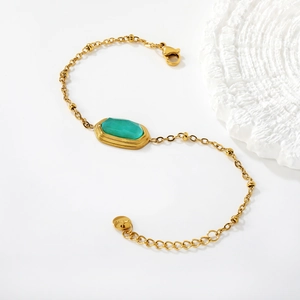 Minimalist 18k gold plated stainless steel bracelet featuring a green emerald-cut stone