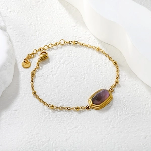 18k gold plated stainless steel bracelet with rectangular purple stone on marble stone