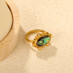 Retro 18K gold-plated ring with oval abalone shell inlay on warm sand background