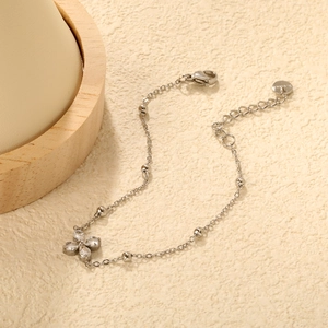 Detail of silver clover bracelet with white zircon stones and adjustable lobster clasp
