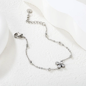 Detailed view of silver bow-knot bracelet with teardrop zircon and lobster clasp