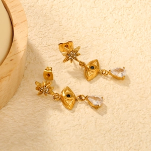 Détails de boucles d'oreilles étoile et œil dorées avec zircon clair en forme de larme