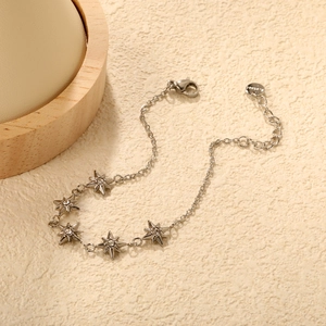 Silver stainless steel bracelet with five sparkling star charms and lobster clasp closure