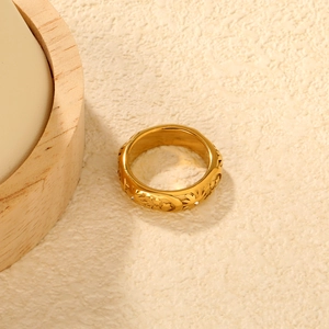 Gold celestial wide ring featuring embossed sun, moon and floral patterns with crystals