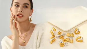 Detail showing mixed gold and silver stainless steel jewelry with tiered coin necklaces