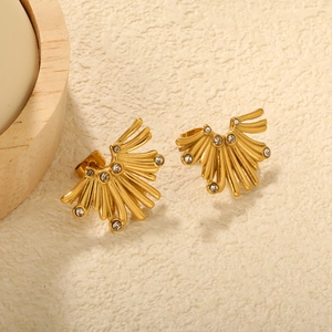 Golden fan-shaped earrings with rhinestones on a textured background for women