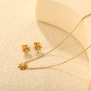 Golden stainless steel flower jewelry set featuring white zircon daisy necklace and earrings