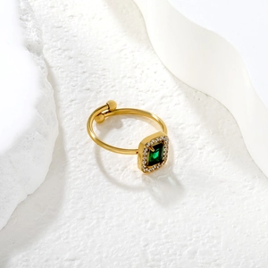 18k gold geometric open ring with emerald-cut green gemstone and cubic zirconia halo