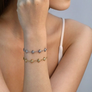 Eight-pointed star charm bracelets in gold and silver finish with sparkling crystals