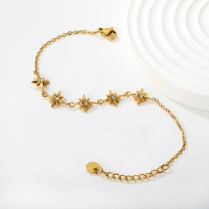 Detailed macro view of the gold-plated stainless steel star bracelet with lobster clasp