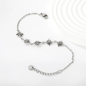 Detailed macro view of silver stainless steel star bracelet with sparkling crystals