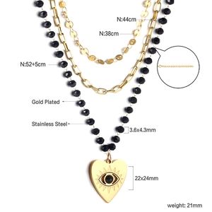 Detailed view of triple-layered gold-plated stainless steel necklace with evil eye heart charm
