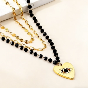 Three-layer stainless steel necklace featuring black beads and heart evil eye pendant