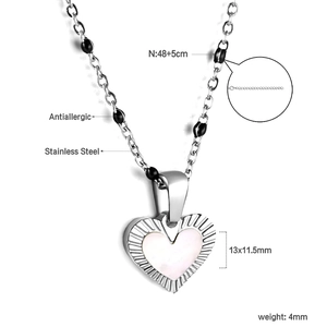 Detail of heart pendant necklace with black beads on 18K gold plated stainless steel