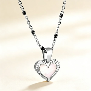 18K gold-plated necklace with heart shell pendant and black beads on a delicate chain