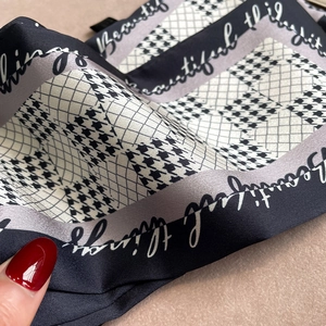 Détail d'un foulard en soie à motif pied-de-poule avec texte cursif Beautiful Things