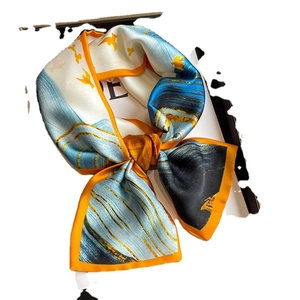 Chic fashion silk scarf with blue ink print and golden birds in an elegant knotted style