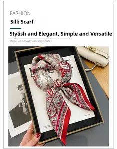 Detailed macro shot of red paisley silk scarf with elegant stitching on a neutral background