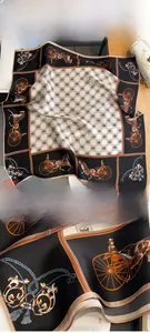 Close-up of silk scarf featuring carriage prints and premium hand-rolled edges
