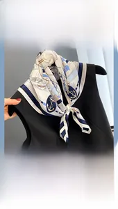 Detail of nautical mulberry silk scarf with navy anchors tied on a black dress neck
