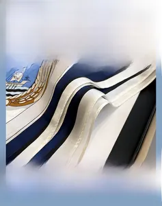 Detailed view of nautical striped silk scarf with sailboat logo and rolled edge stitching