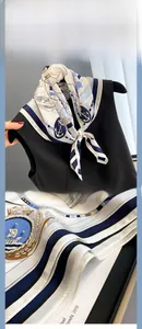 Detailed view of nautical anchor and sailboat patterns on a premium white silk scarf