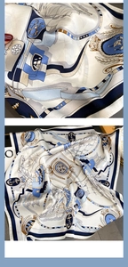 Detailed close-up of nautical silk scarf featuring navy anchors and compass patterns