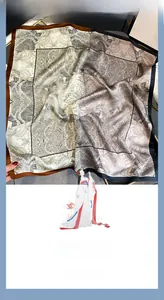 Detail of silk scarf showing vintage phoenix patterns and premium satin texture
