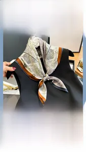 Close-up of elegant mulberry silk scarf with vintage botanical prints and brown border