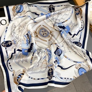 Elegant silk scarf with nautical sailing pattern in navy blue and gold accents