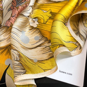 Detail of silk scarf showing floral print and fine hand-rolled edges texture