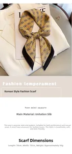 Detail of 70x70cm yellow silk scarf with bow print laid on a white suit and magazine