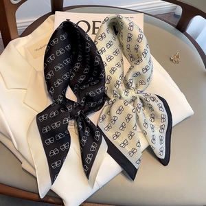 Detail of silk-texture neckerchiefs with butterfly patterns on a white blazer