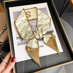 Vintage horse print silk neck scarf with letter S tied in a bow in luxury gift box